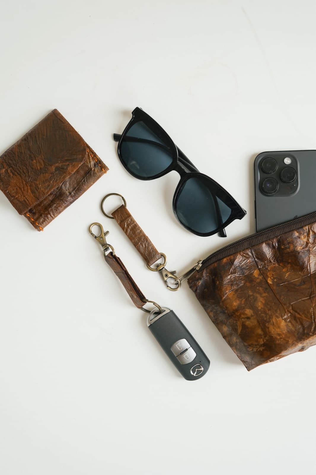 Symbia bioleather wallets, keychains, and accessories arranged flat