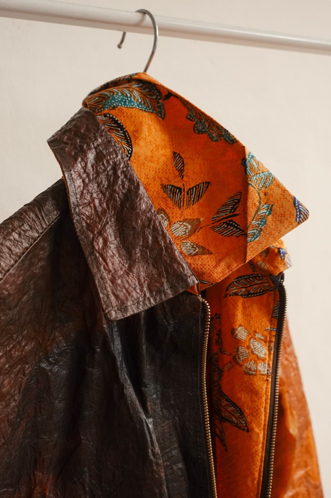 A patterned Symbia jacket on a hanger