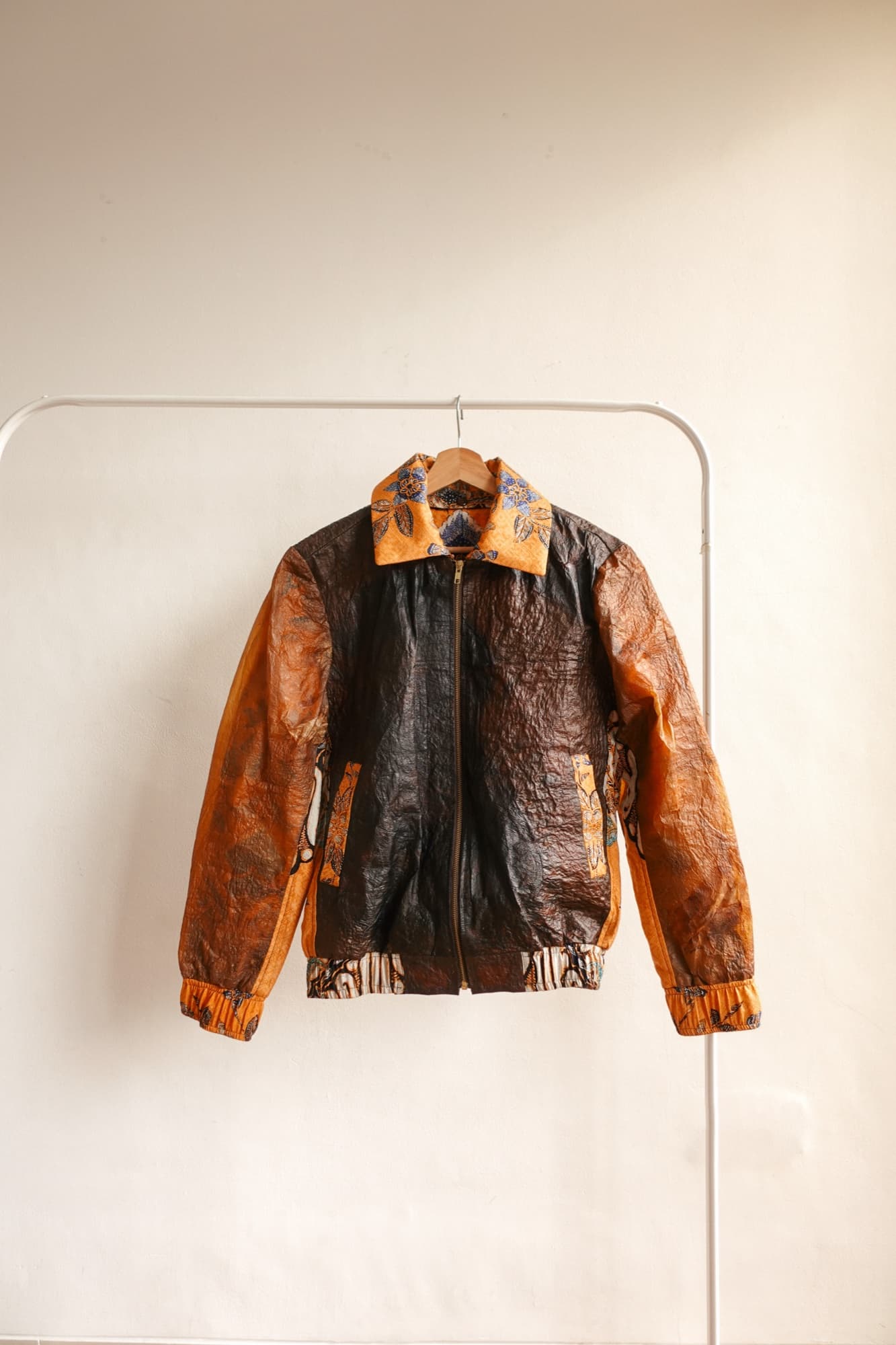 A batik-panelled Symbia jacket on a rack