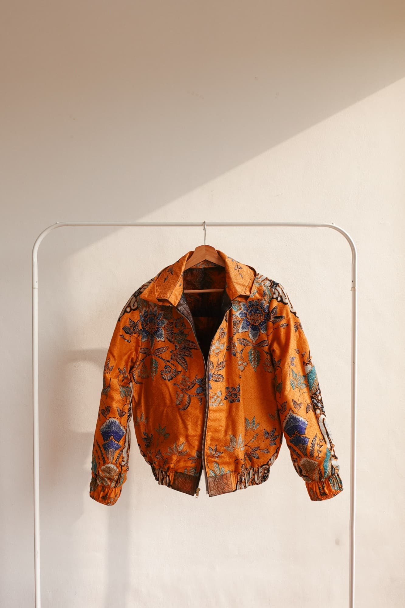 A Symbia jacket with an orange batik lining