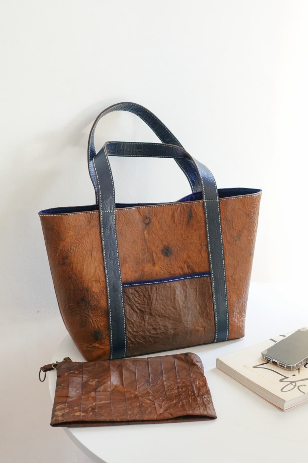 A Symbia tote bag with blue handles