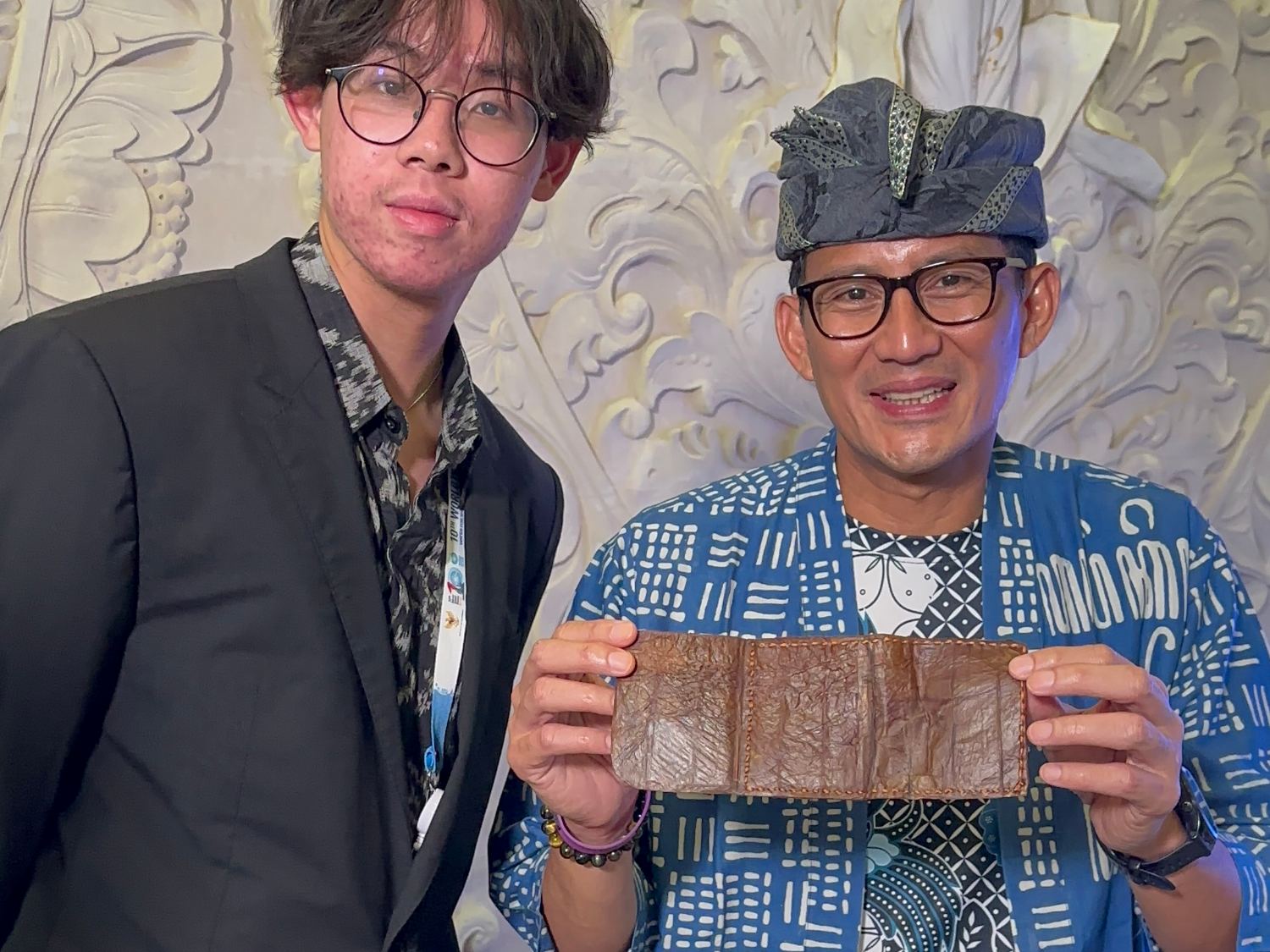 Rayden Yap presenting a sheet of Kombucha Bioleather to a government official